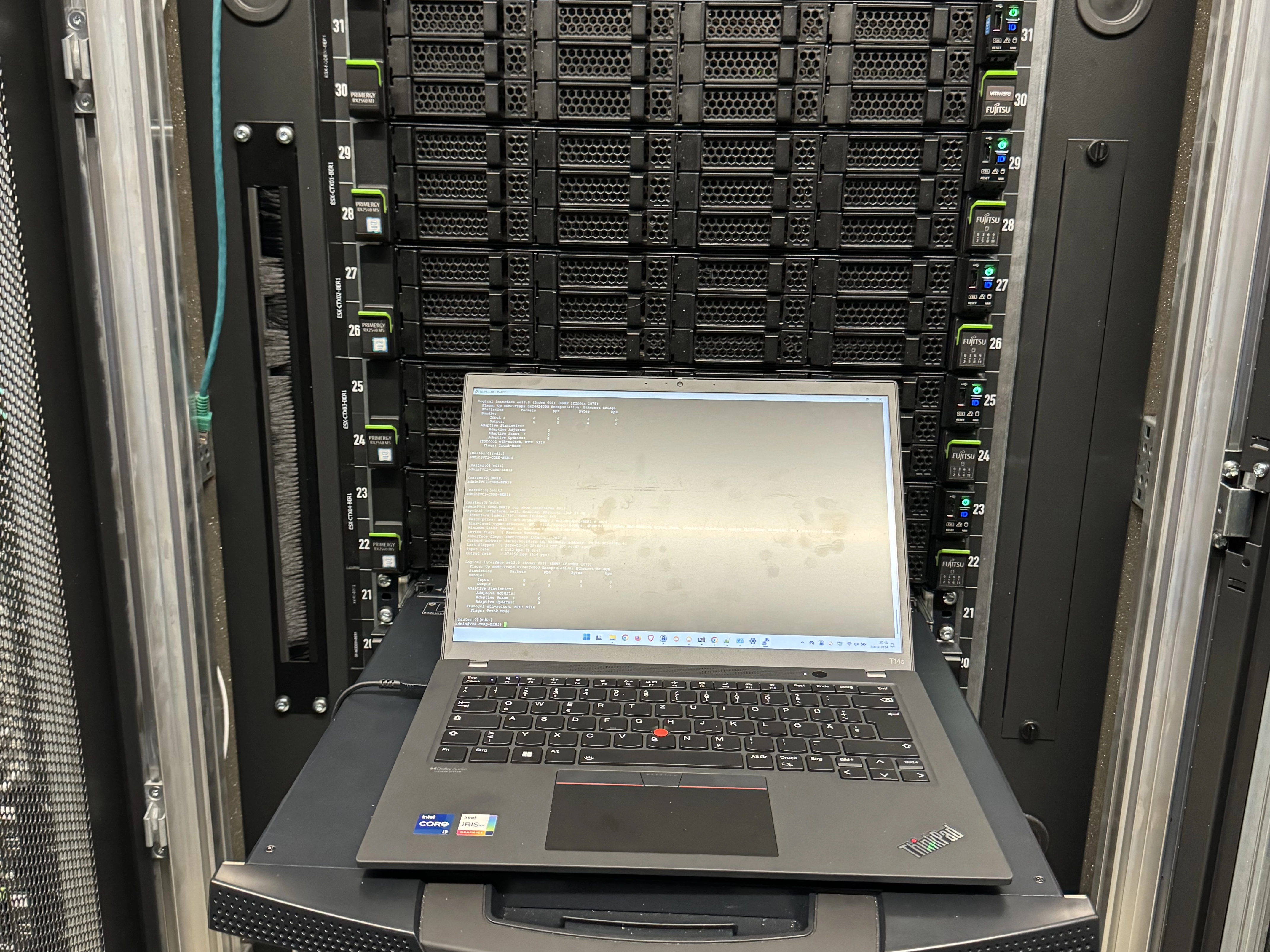 An open laptop at a server rack